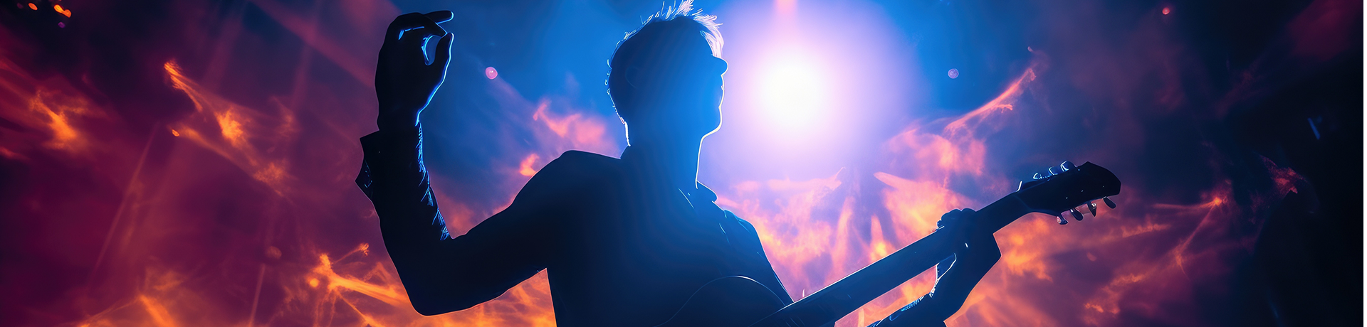 Musician silhouette with guitar against fiery stage lighting